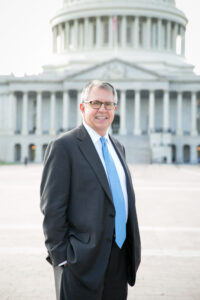Redding, ASA Washington, D.C. Representative, standing in front of the U.S. Capitol building.