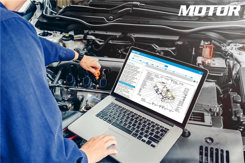 Technician looking up MOTOR's Wiring Diagrams to repair a vehicle.