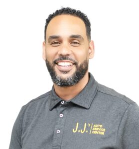 JJ Mont of J.J.’s Auto Service Center smiling in a branded gray polo shirt against a white background.