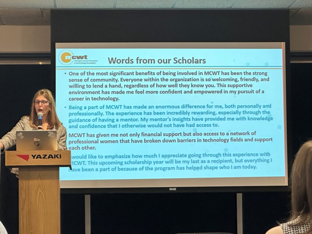 Presenter on stage at the MCWT scholarship event.