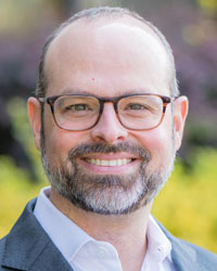 Paul McCarthy, President of MEMA Aftermarket Suppliers, smiling in an outdoor professional headshot.